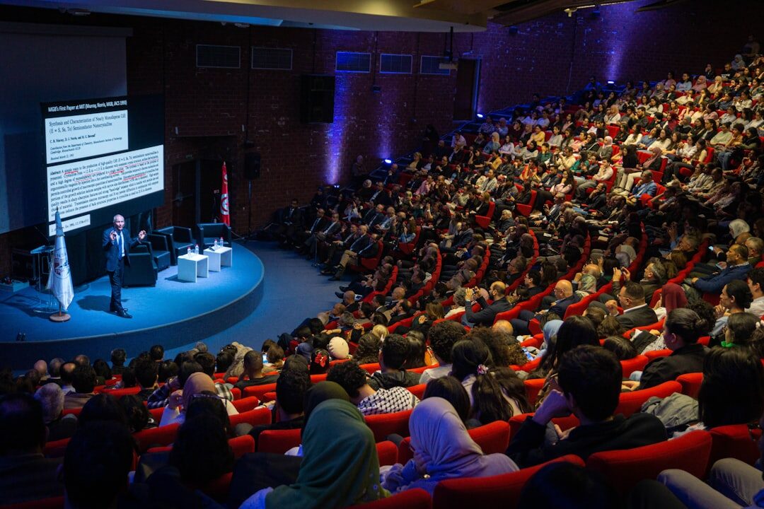 Corporate conference with audience and speaker on stage